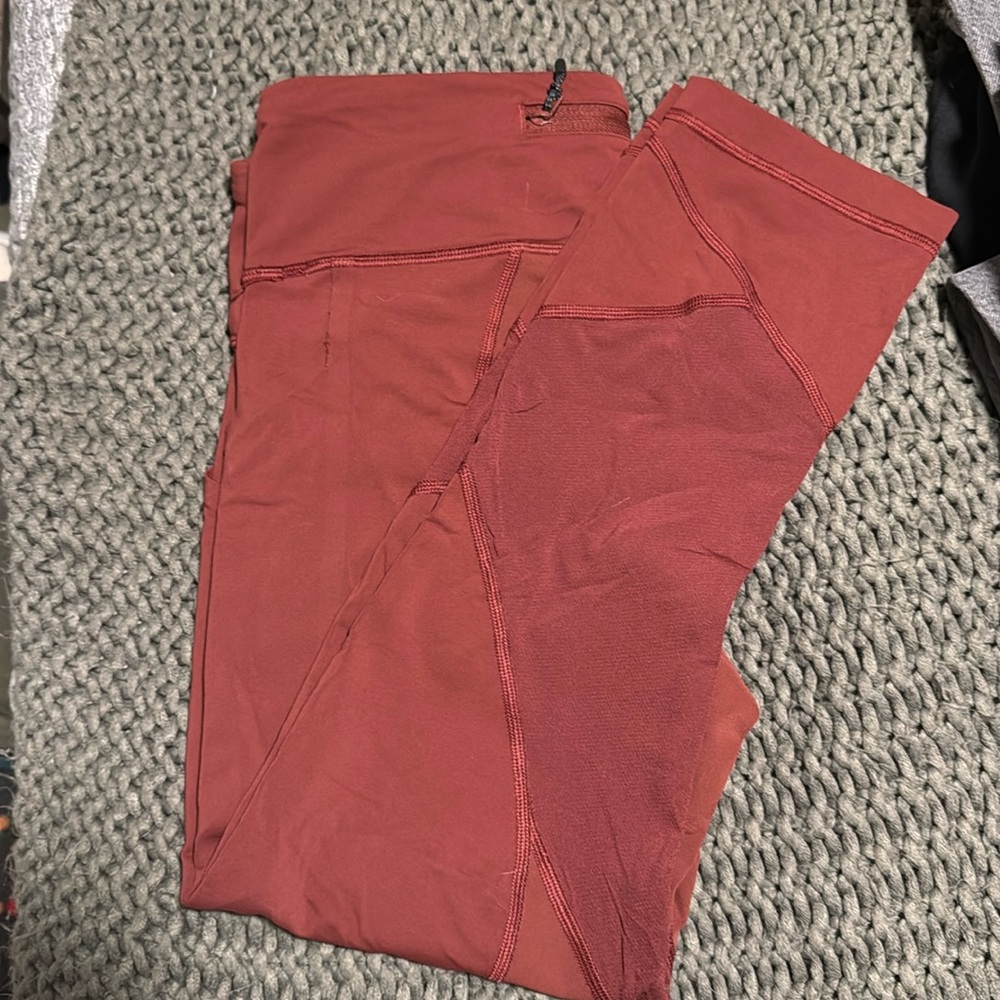 Lululemon leggings, dark burgundy color size 8, 23 in with mesh details